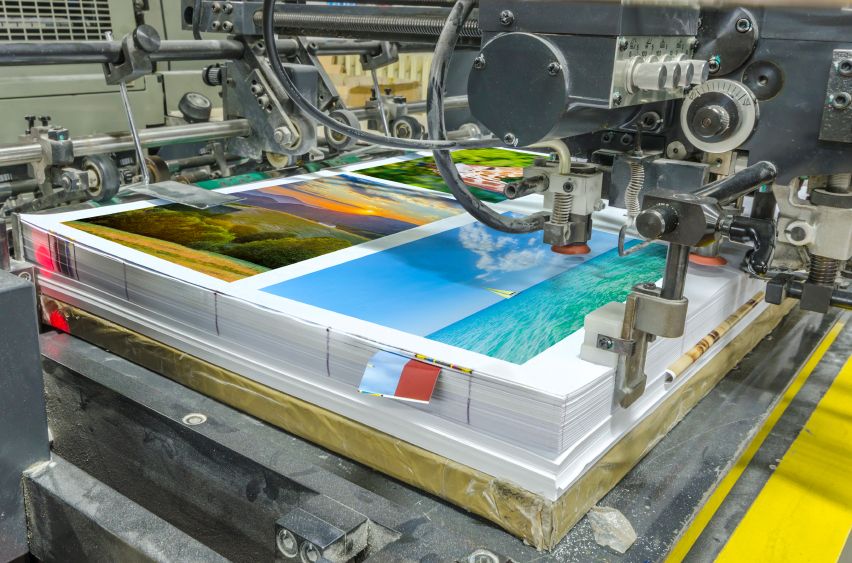 Colour printed sheets with landscape photos on a press