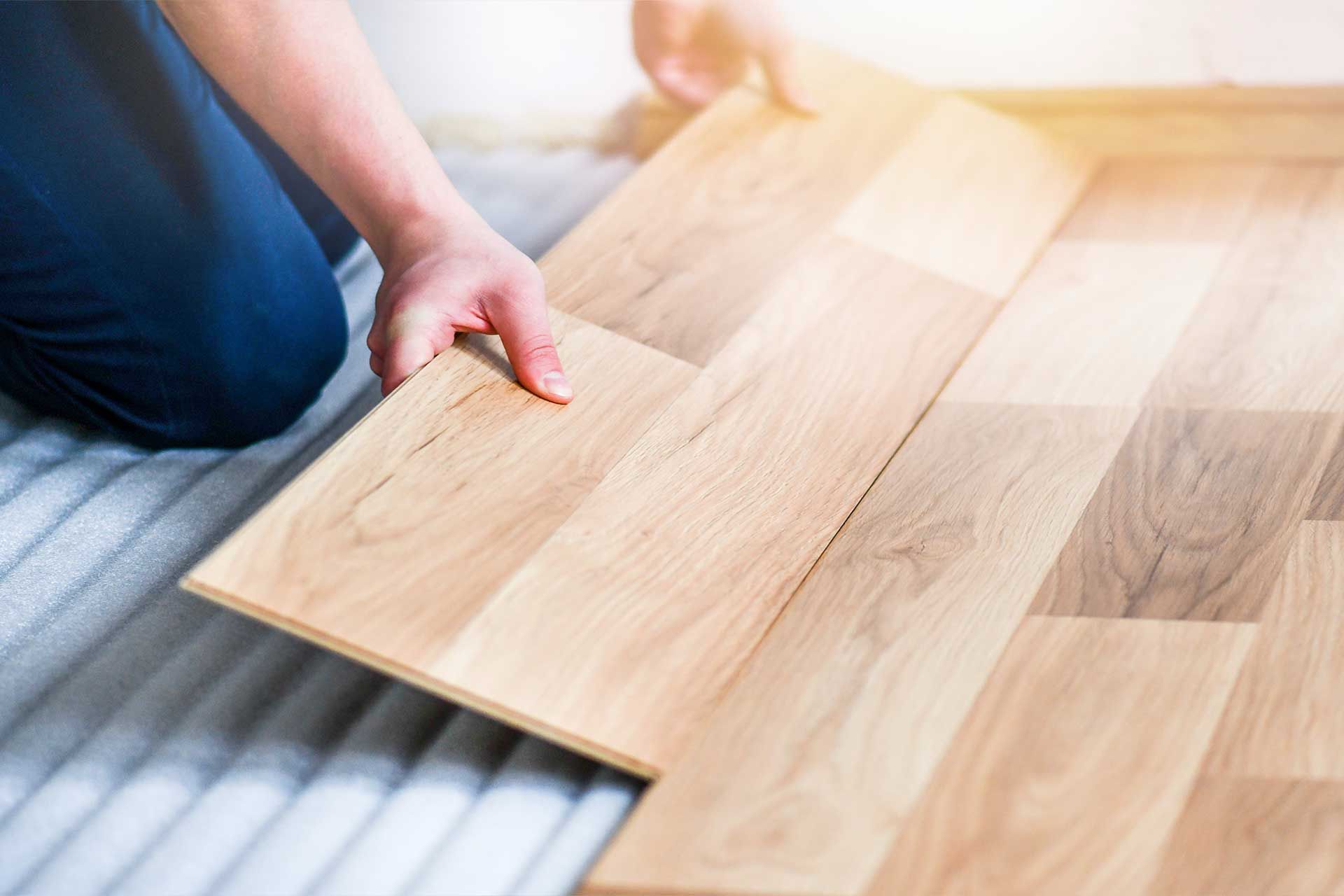Wood flooring planks being laid onto underlay