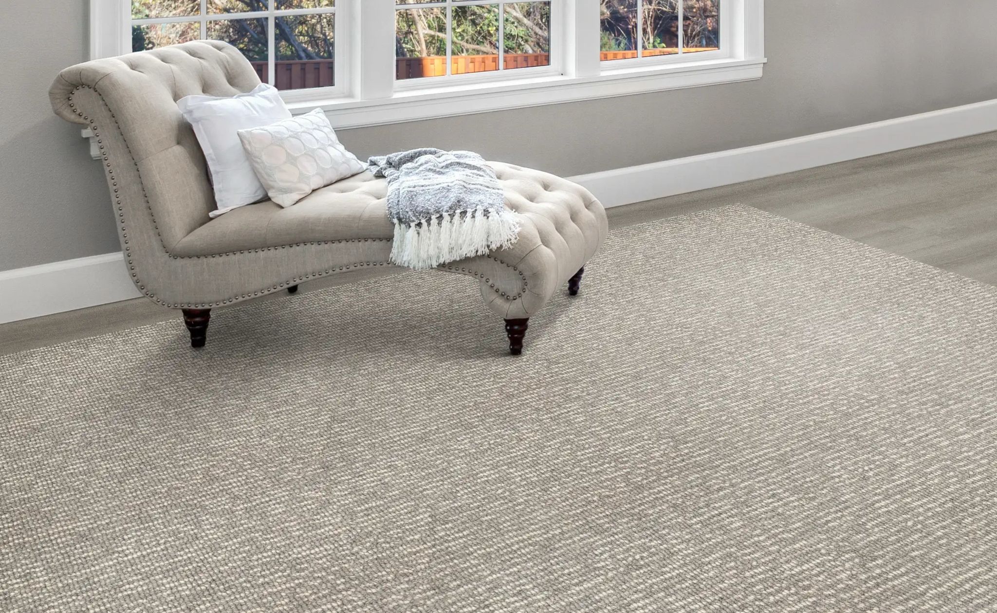 Beige textured carpet under a chaise longue