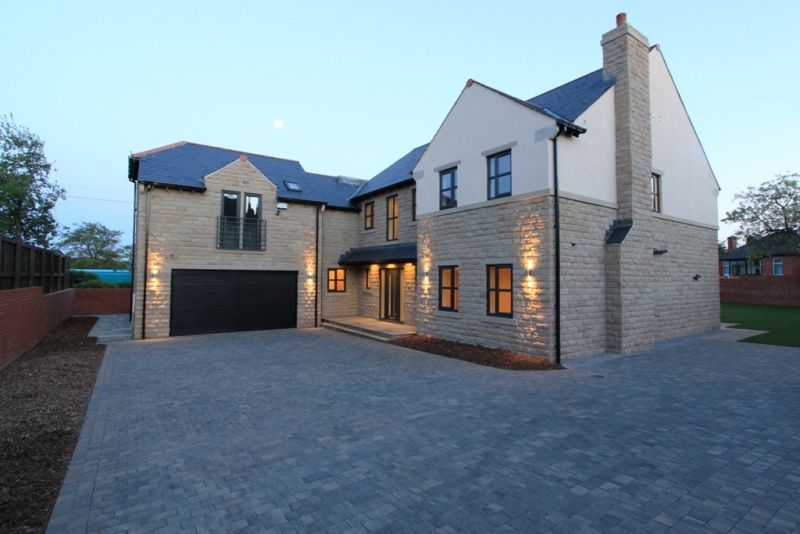 Dark windows on a stone house at dusk